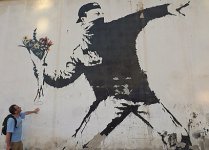 Banksys_flower-throwing_protester._(17801207806).jpg